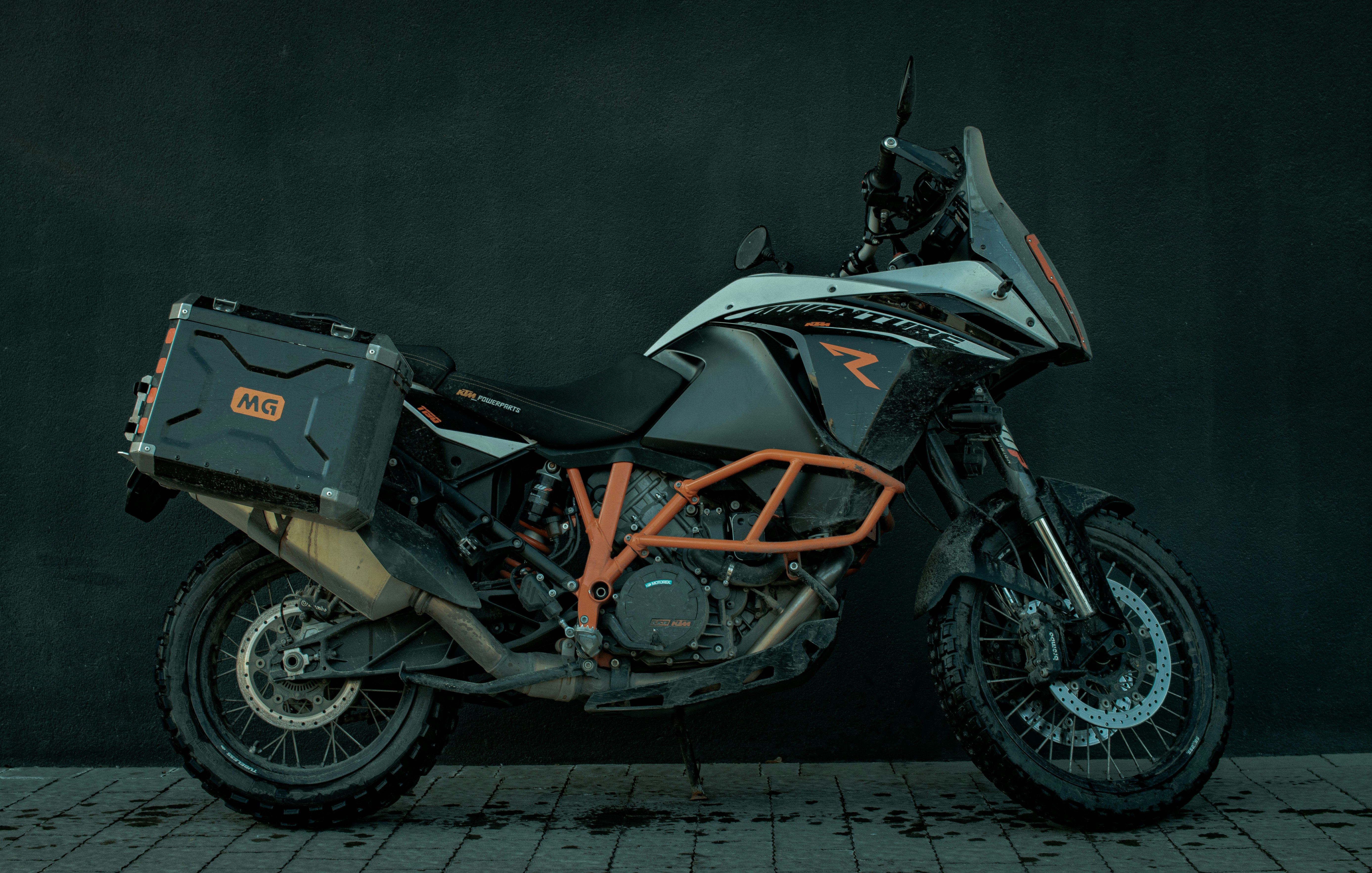 black and orange motorcycle parked on gray concrete floor